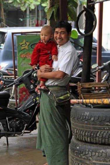 Burmese man sporting a green longyi