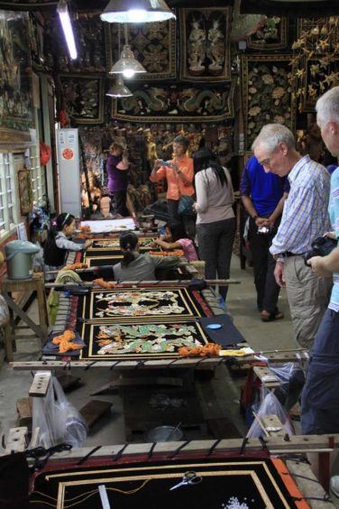 Checking out a kalaga tapestry workshop in Mandalay