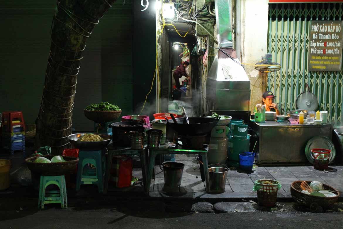 Steam from delicious street food snacks fills the street