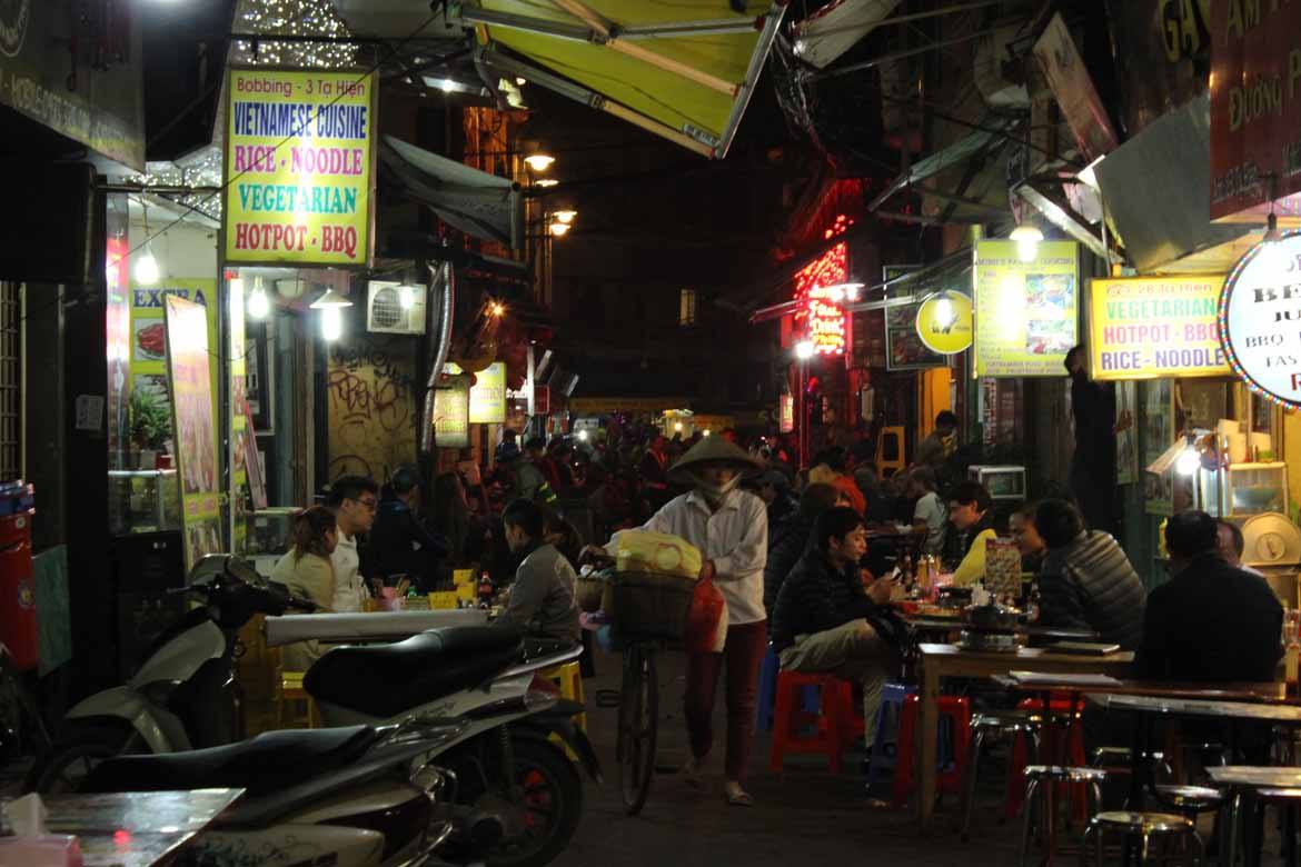 Squeeze between tables at an outdoor restaurant