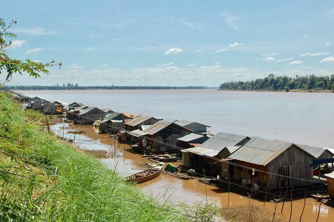 A floating Vietnamese village is anchored to the island by cables.