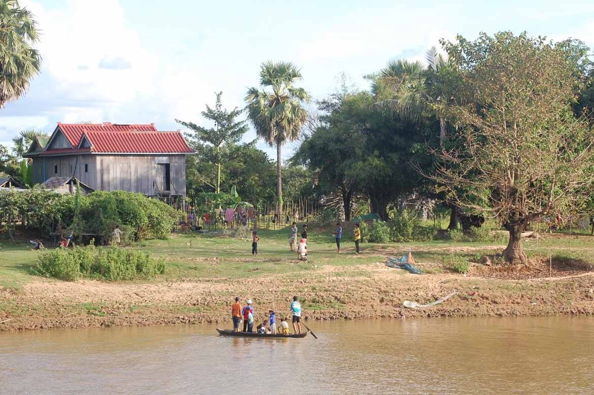 These boys cross the river for a game of footy with their mates on the other side.
